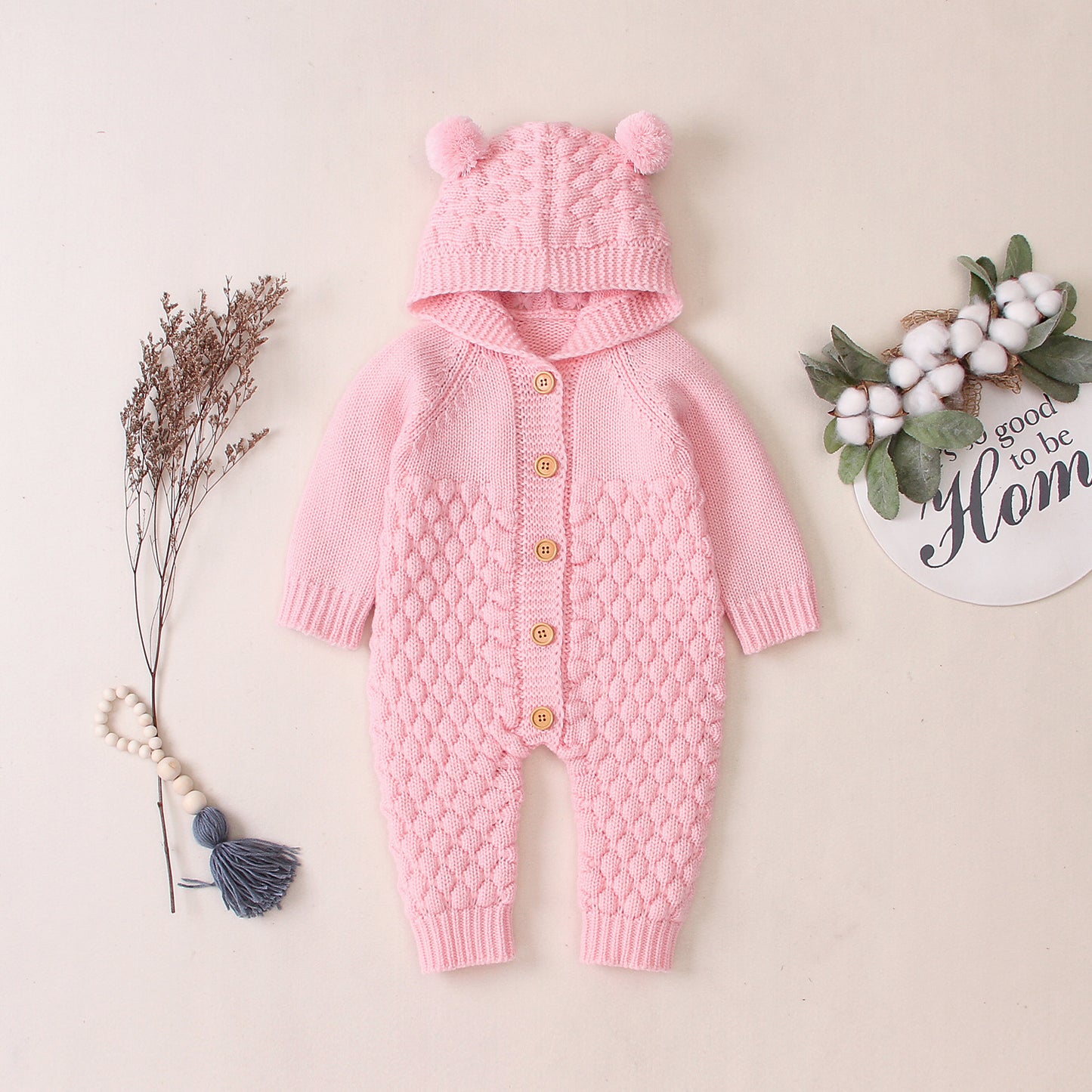 Combinaison-grenouillère bébé à capuche tricotée et boutonnée